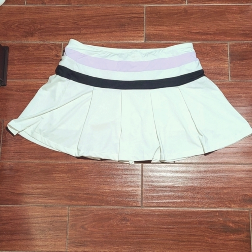 Slazenger white golf skirt with with two lines and the waist band